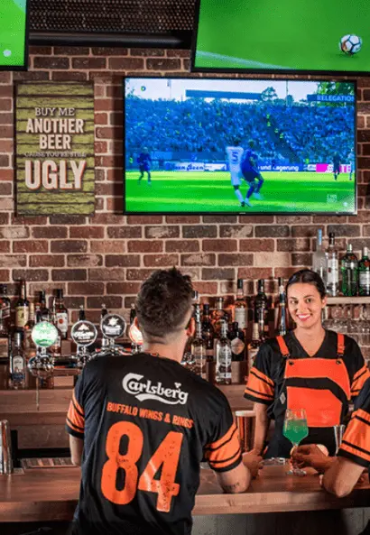 people in a bar watching sport