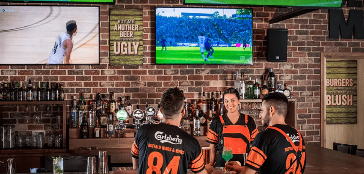 people in a bar watching sport